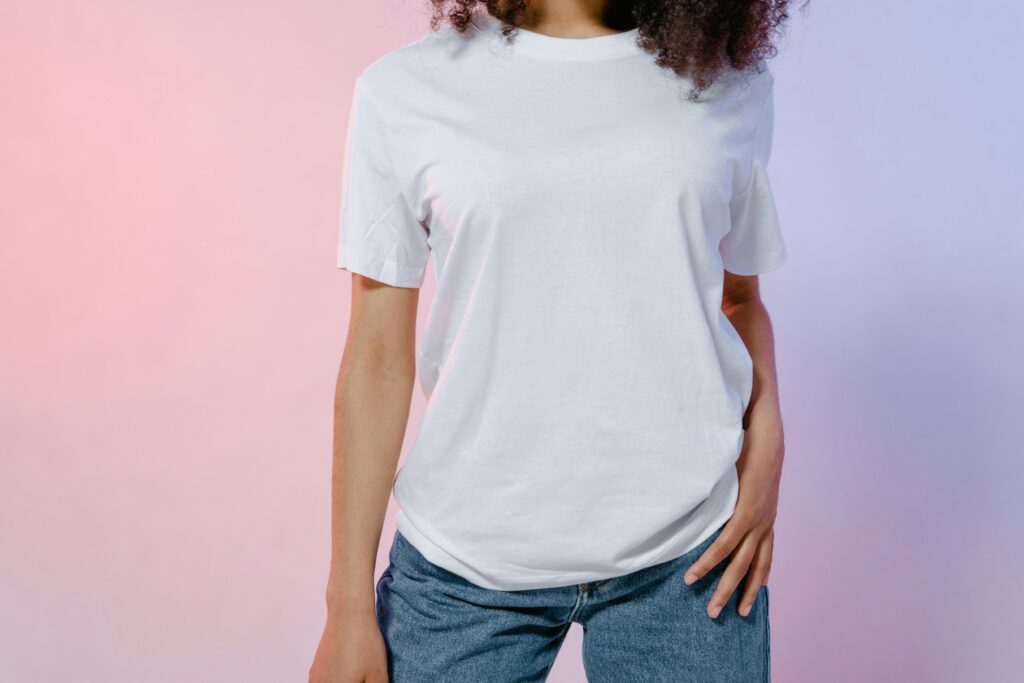 White blank t-shirt with blue jeans on pastel background